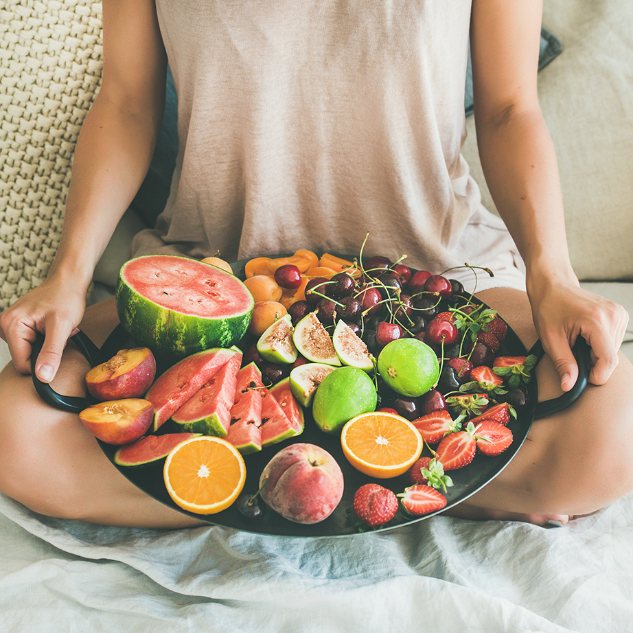 woman holding fruit tray