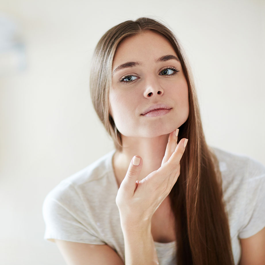 woman looking at skin 